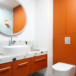 biała łazienka pomarańczowe dodatki