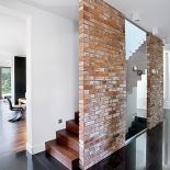 Elementem dekoracyjnym jest ściana z cegieł - taka sama jest także w kuchni.