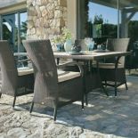 Fotel Mayfair firmy Cane Line zrobiono z włókna hularo (1619 zł), stół - z drewna tekowego i hularo (180