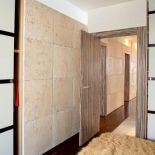 Imponująca kamienna ściana z trawertynu jest w sypialni, holu i salonie.