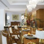 CIEKAWE, MOSIĘŻNE KINKIETY CIRCLE – VENICEM OBOK OBRAZU TOMKA SĘTOWSKIEGO. NAD STOŁEM KRYSZTAŁOWE ŻYRANDOLE –