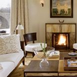 Jasne obicia kanapy i krzeseł. Apartament w kamienicy na Powiślu