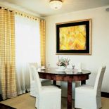 Krzesła w pokrowcach świetnie komponują się ze stołen w stylu art deco.