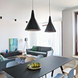 W salonie kanapa z drewnianymi nóżkami nawiązująca kształtem do lat 60. (Nap)