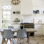 Miks stylu nowoczesnego z rustykalnym. Stół ze starych chińskich drzwi. Nad nim francuski żyrandol, do