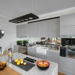 Minimalizm plus lustrzane kafelki i blaty z białego marmuru.