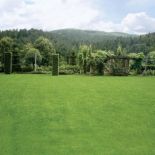 Ogród ukryty wśród gór. Tarasowy ogród otoczony naturą