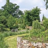 Ogród ze stawem, altankami i ławeczkami do dumania.