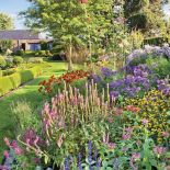 Czy klomby kwiatów we wszystkich barwach tęczy pasują do nowoczesnego domu