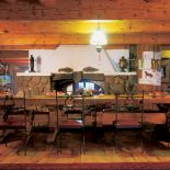 Parter domu to ogromna, przestronna izba podzielona na pół ścianą z kominkiem.