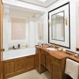 Pomysłowy schowek: za lustrem znajduje się płytka szafa na szlafrok i reczniki.