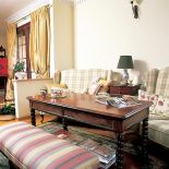 Przy drewnianym stoliku miejsce znalazły kanapy i bankietka.