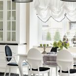 Stół i krzesła to projekt architektki. Czarne lampy nad wyspą - Leroy Merlin.