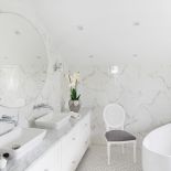 Biała łazienka z marmurem na ścianie