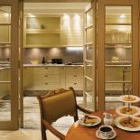 Szafki w kuchni zaprojektował Wiesław Olko. Żeby dodać elegancji i palacowego szyku, fronty pokryto szlagmetalem