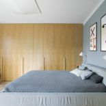 szara sypialnia z drewnianą szafą