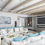 Szare meble zrobione zostały na zmówienie, kanapy i stoliki z firmy Baltus, wieża od Bang Olufsen. Obrazy namalował