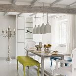 Także tu nie mogło zabraknąc żartu. Kolorowe ławy, kandelabr i porcelanowe lampy nad stół przyjechały ze sklepu Le