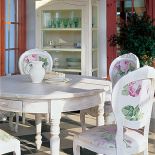 Tkanina obiciowa na krzesłach komponuje się z ornamentami na serwantce.