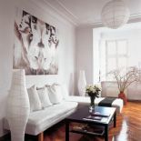 W salonie dużo bieli i kontrastujący czarny stolik.