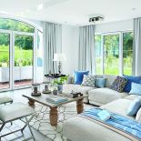 W salonie pledy i błekitne poduchy są z NAPu. Dywan z marokańskim wzorem, stolik-taca i świeczniki to Mint Grey,