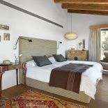 W sypialni artdekowski stolik, francuski fotel i rustykalna komoda.