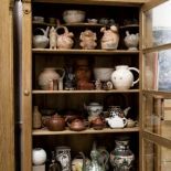 Witryna wypełniona posążki i naczyniami.