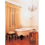 Wolnostojąca wanna z kontrastowymi czarnymi nóżkami.