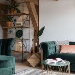 salon z zieloną sofą i zielonym fotelem