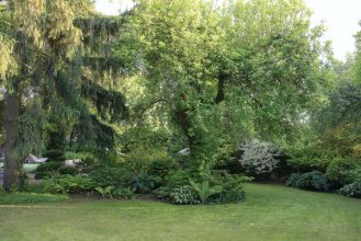 ogród ze starymi drzewami i zakątkami do odpoczywania