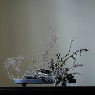 kompozycja ze sztucznych kwiatów na tacy