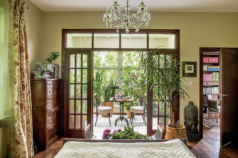 Sypialnia z wyjściem na patio pełne zieleni.