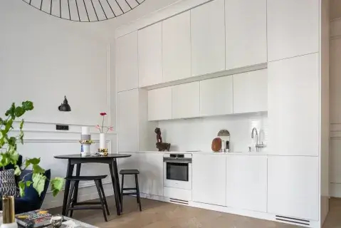 stół w kuchni na tle stylowych sztukaterii