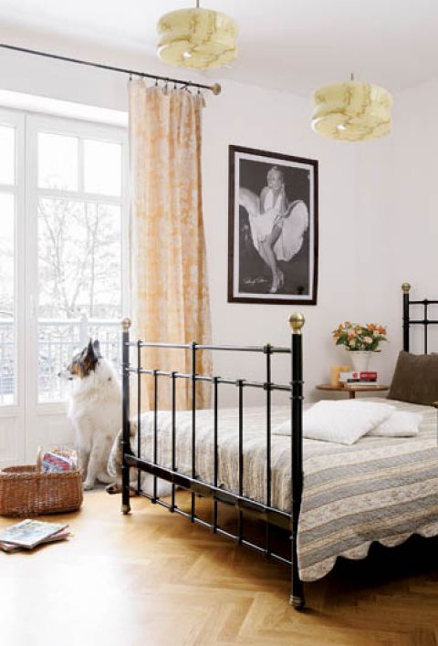 Ściane przy łóżku zdobi fotografia przedstawiająca Marilyn Monroe.