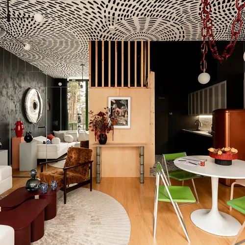 Nowoczesny salon w loftowym apartamencie Mateusza Banasiuka z ciemnymi ścianami i autorskim wzorem na suficie