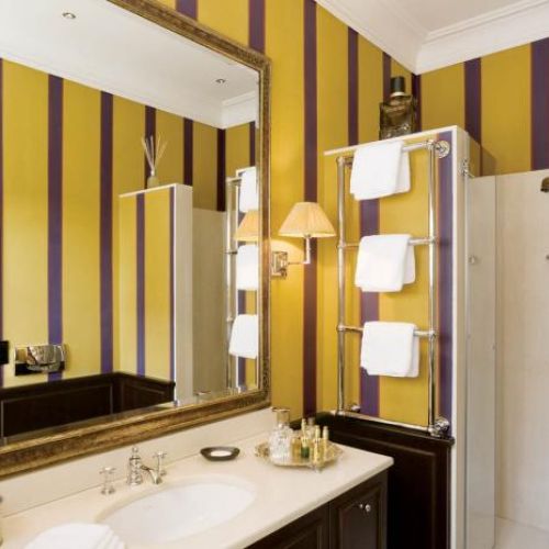 Duże lustro w zdobionej ramie. Apartament pełen smaków