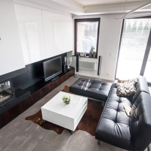 Kominek nadaje przytulności prostemu wyposażeniu salonu.