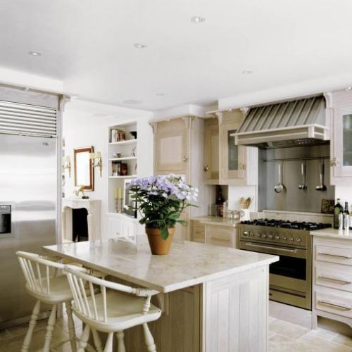 Kuchenne szafki zrobiono z bielonej dębiny, a blaty z piaskowca. Dla kontrastu, w jadalni obok