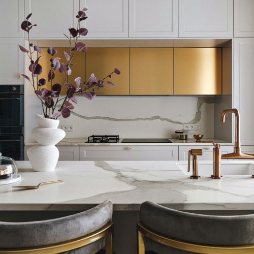 biała kuchnia ze złotymi dodatkami