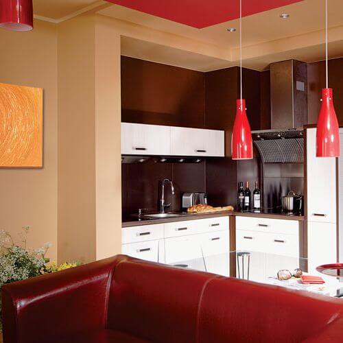 Śnieżna bel kuchennych szafek kontrastuje z barwnym wnętrzem.