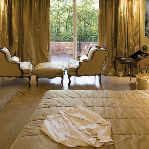 Sypialnia tonie w złocie. Tylko obraz Koronkowy Olgi Wolniak, przypominający wiekową tkaninę, tworzy tu barwny kontrast.