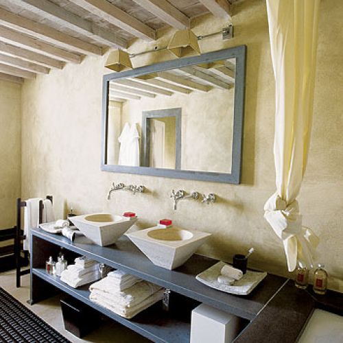 Wysmakowana łazienka. Może to zasługa powtórzeń. Błękitna rama lustra, błękitna półka, futryna. Taki sam kształt