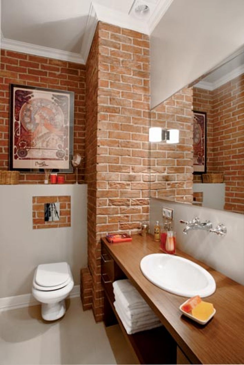Charakter tej łazience nadaje ceglana ściana.