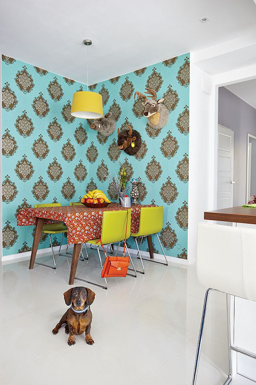 Kolorowe dodatki: turkusowa tapeta, limonkowe krzesła, soczyste odcienie na tkaninach.