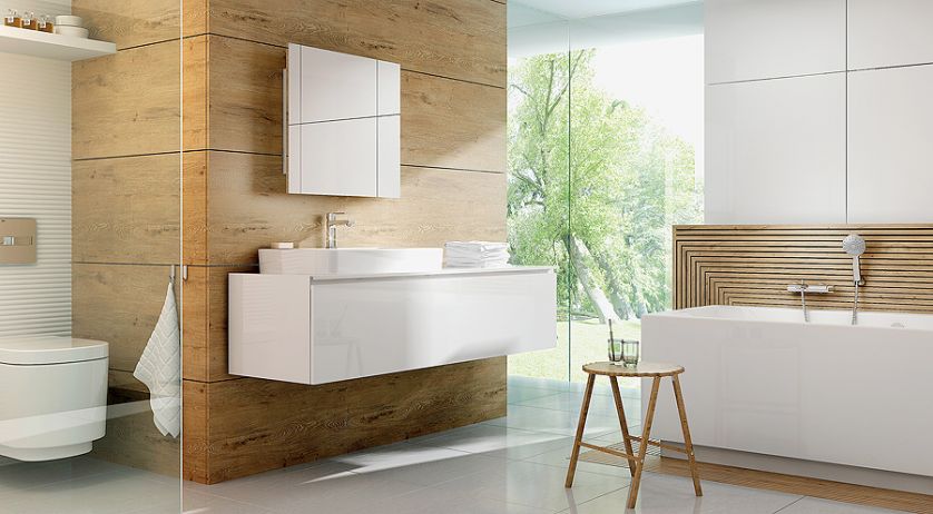 Pomysł na łazienkę według marki Deante. Do drewnianych paneli i białych szafek dodano baterie Lotos, umywalkowa –