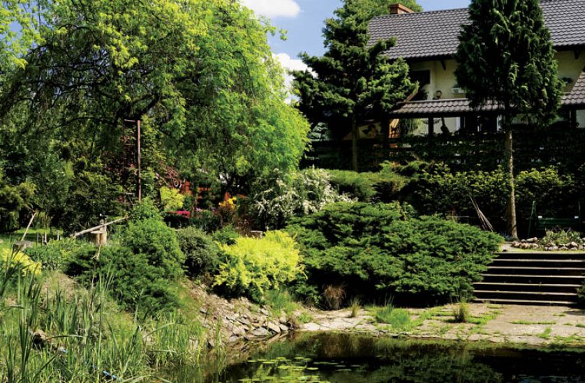 Dom tonie wśród bujnej zieleni, siedząc nad stawem możemy poczuć się jak na wakacjach.