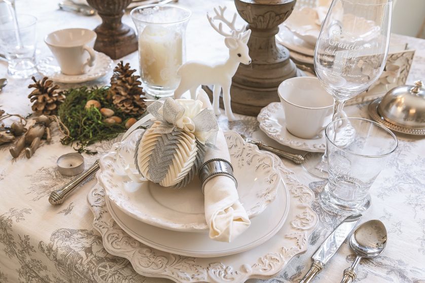 Dekoracja stołu na boże narodzenie: srebrno-białe bombki i zdobione talerze, Belle maison