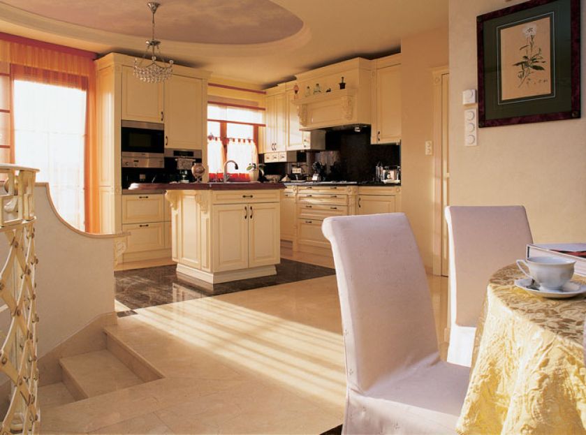 W kuchni znajdziemy jasne szafki z ciemnymi blatami.